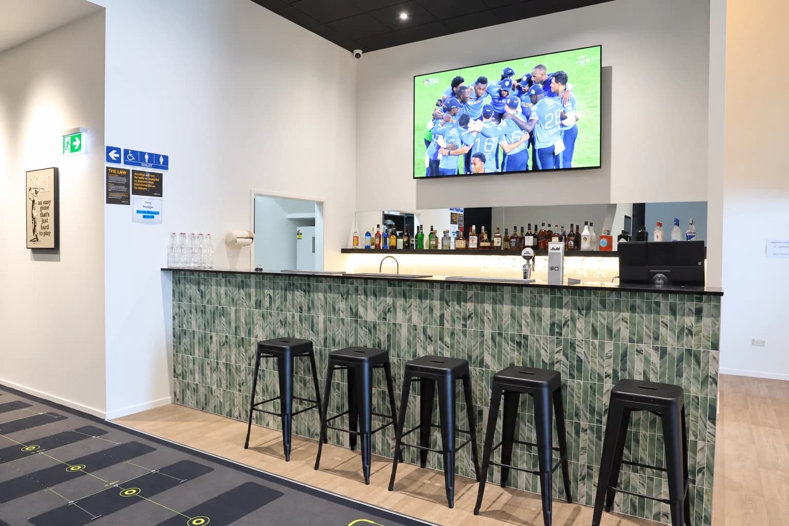 The Tee Bay bar with stools and drinks behind the counter